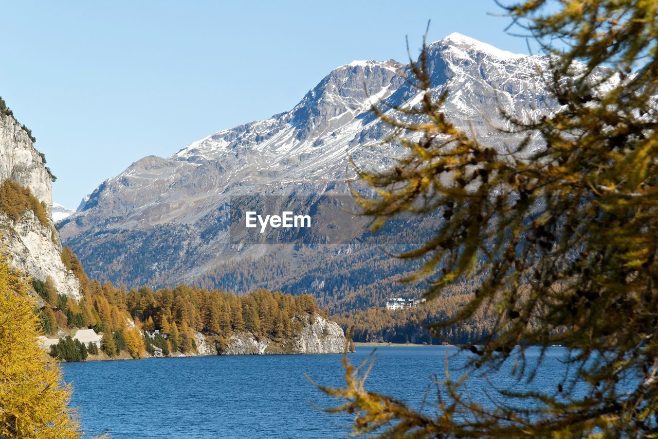 Scenic view of frozen mountains against sky