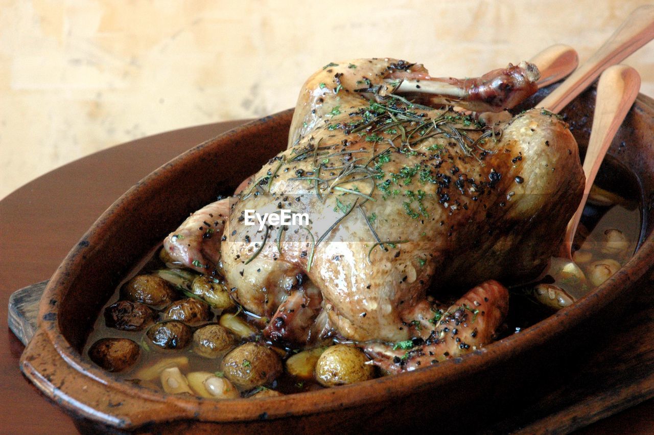 Close-up of roasted chicken in bowl on table