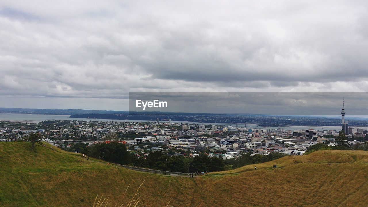 High angle view of cityscape against cloudy sky