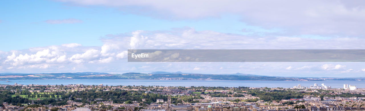 HIGH ANGLE VIEW OF CITY BY SEA