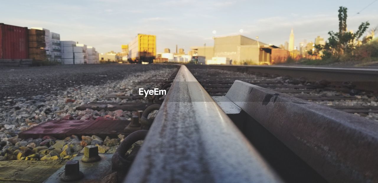 SURFACE LEVEL OF RAILROAD TRACK AGAINST BUILDINGS IN CITY