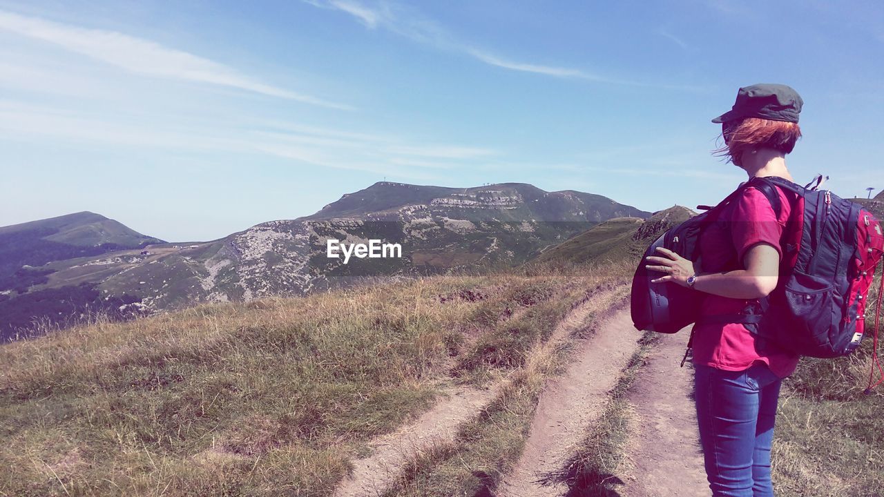 Full length of man standing on mountain road against sky