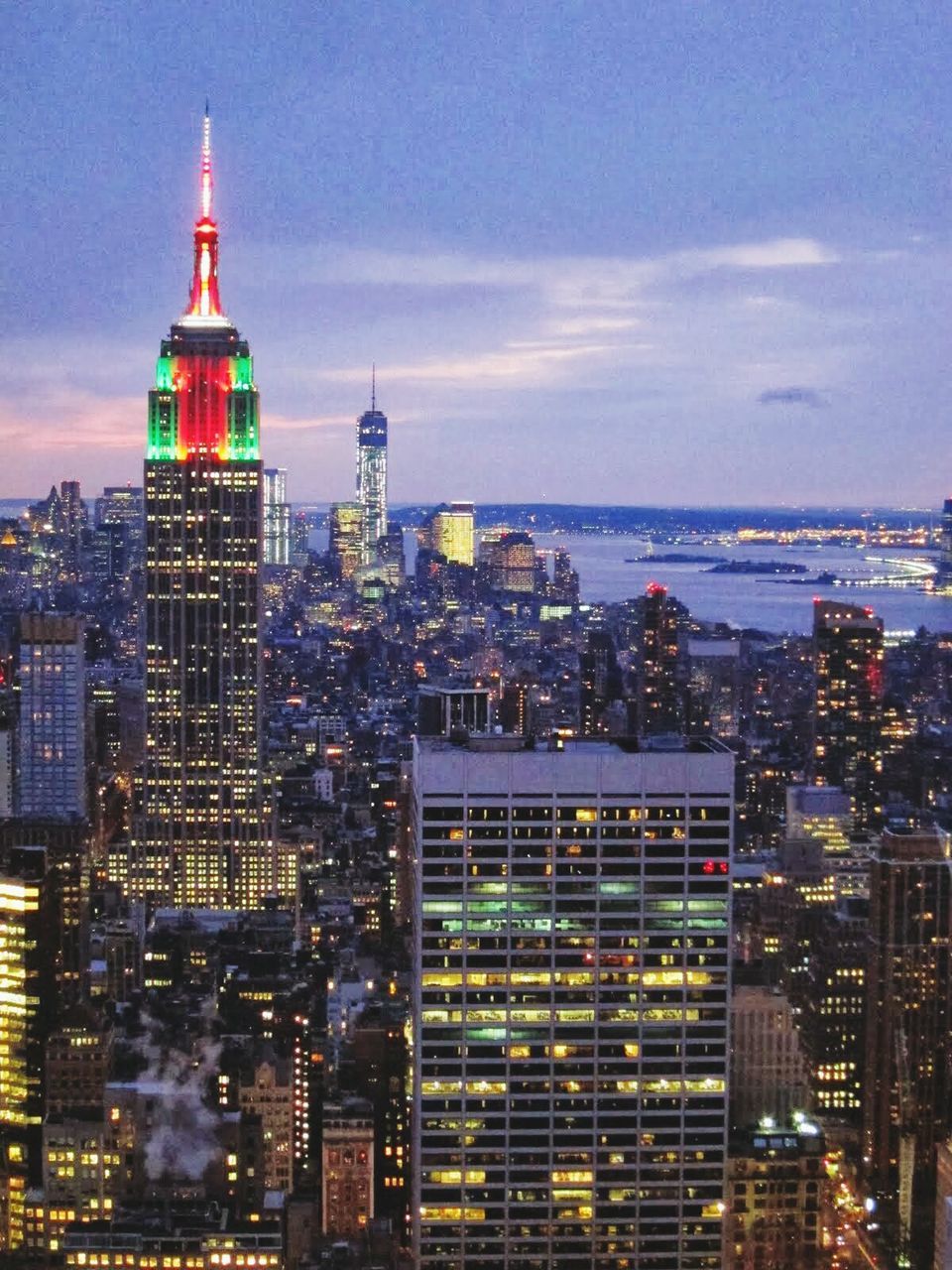 ILLUMINATED CITYSCAPE AGAINST SKY AT SUNSET