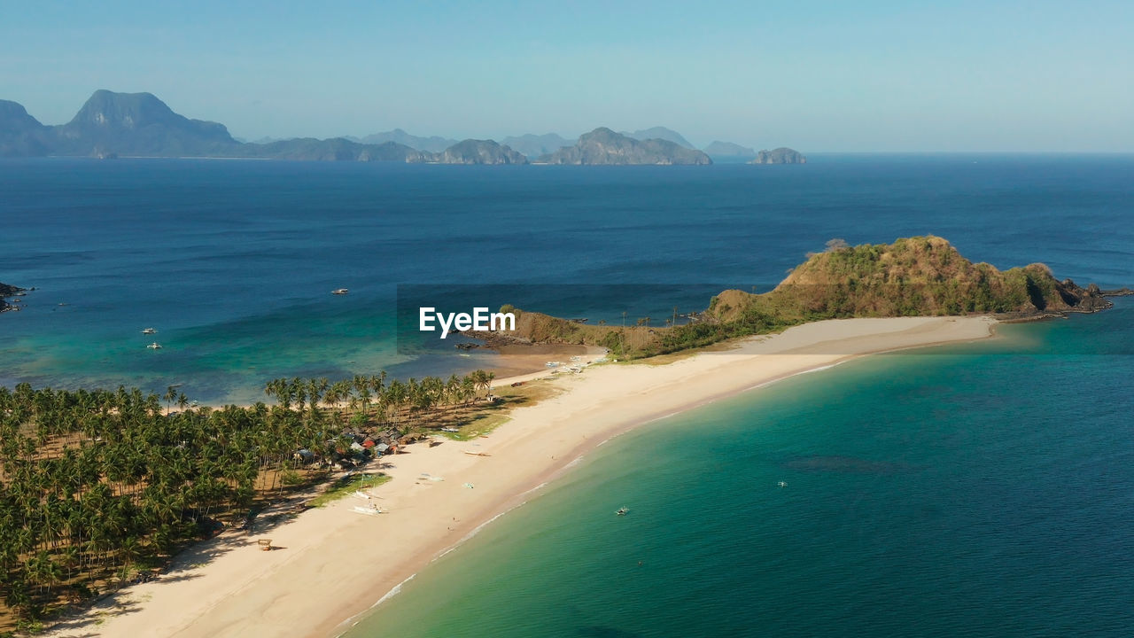 Blue sea and tropical beach, aerial drone. nacpan, el nido, palawan, philippine islands. 