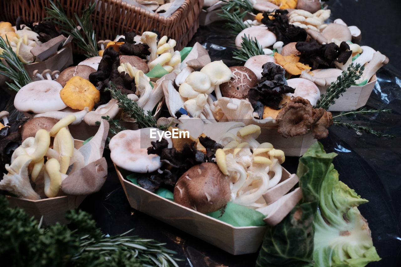 High angle view of edible mushrooms in containers on table