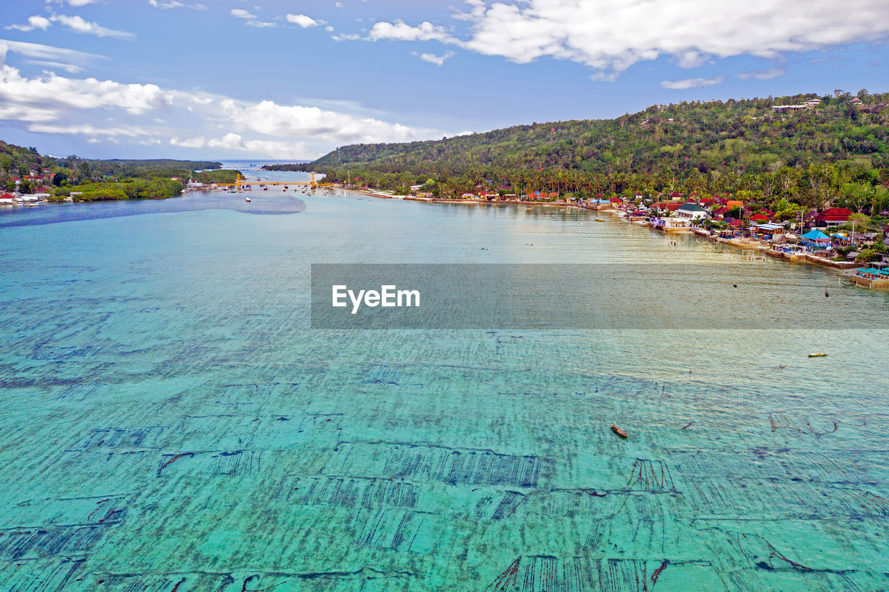 SCENIC VIEW OF BEACH AGAINST BLUE SKY