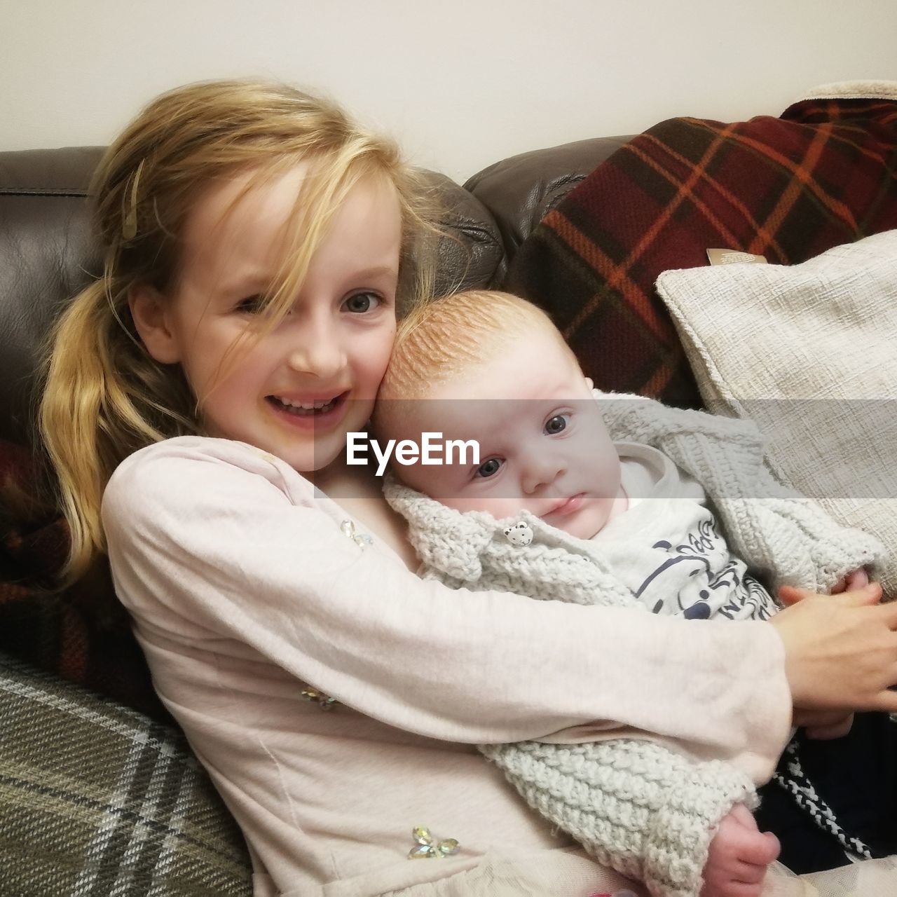 Portrait of cute baby and girl at home