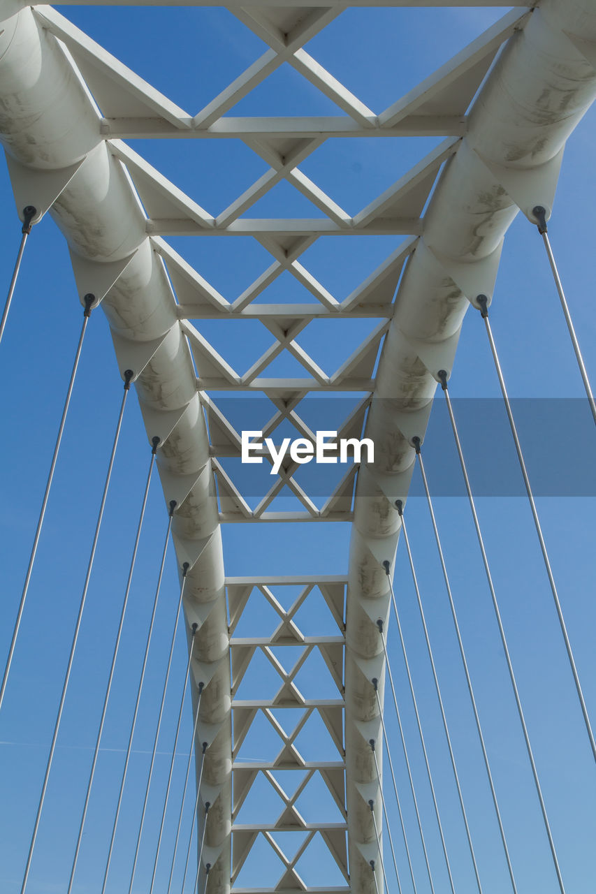 Low angle view of bridge against clear blue sky