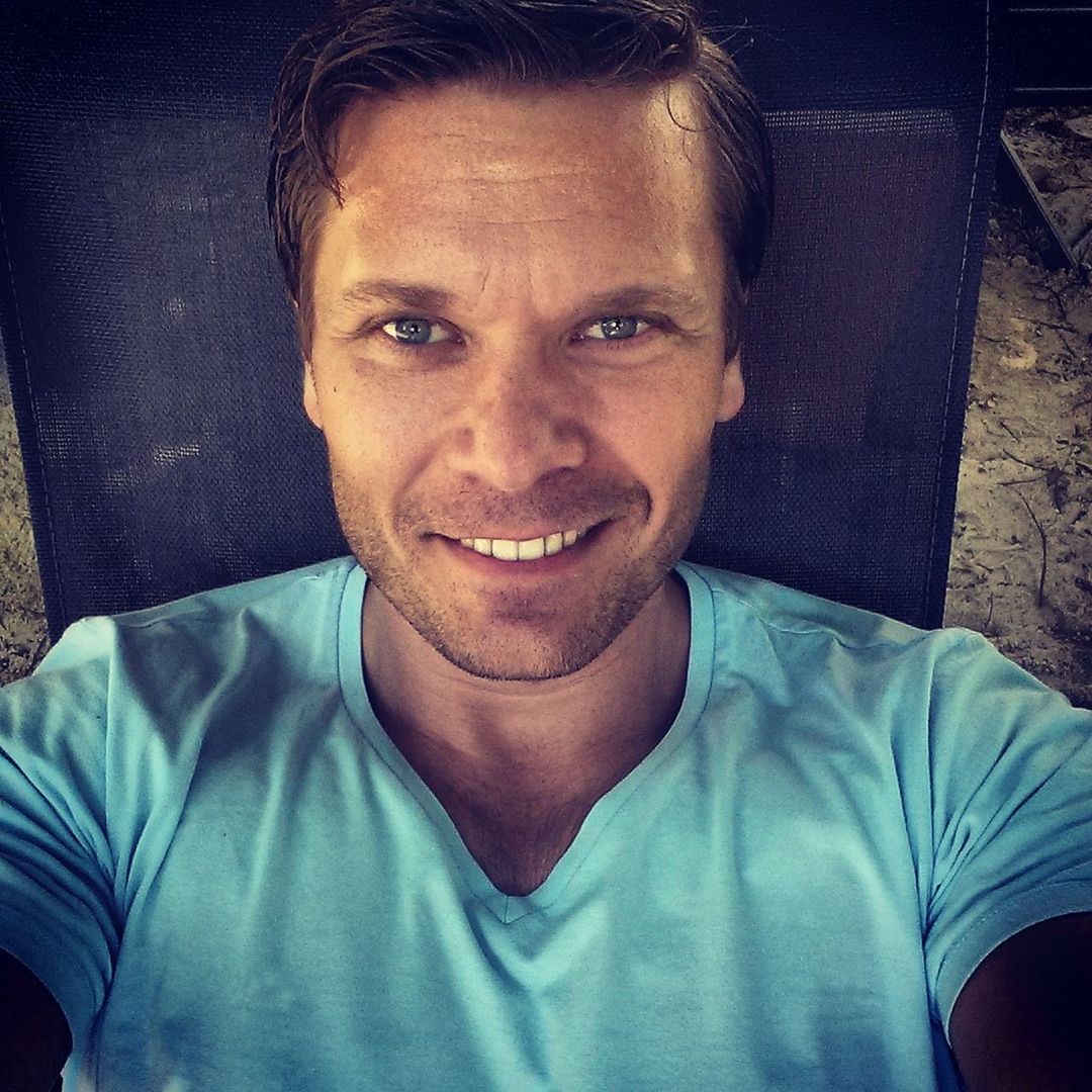 Close-up portrait of smiling handsome man outdoors