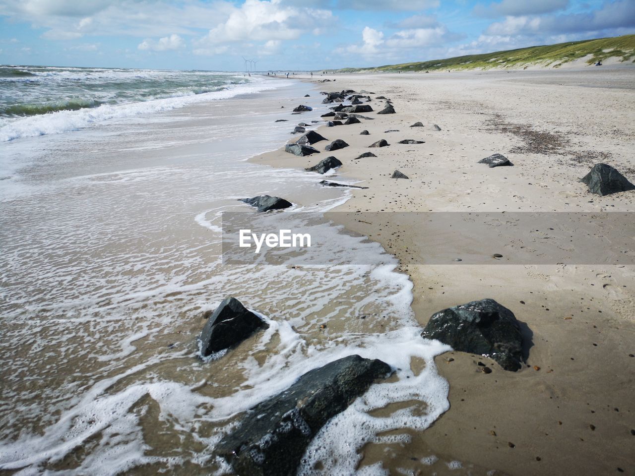 Surface level of sand on beach against sky