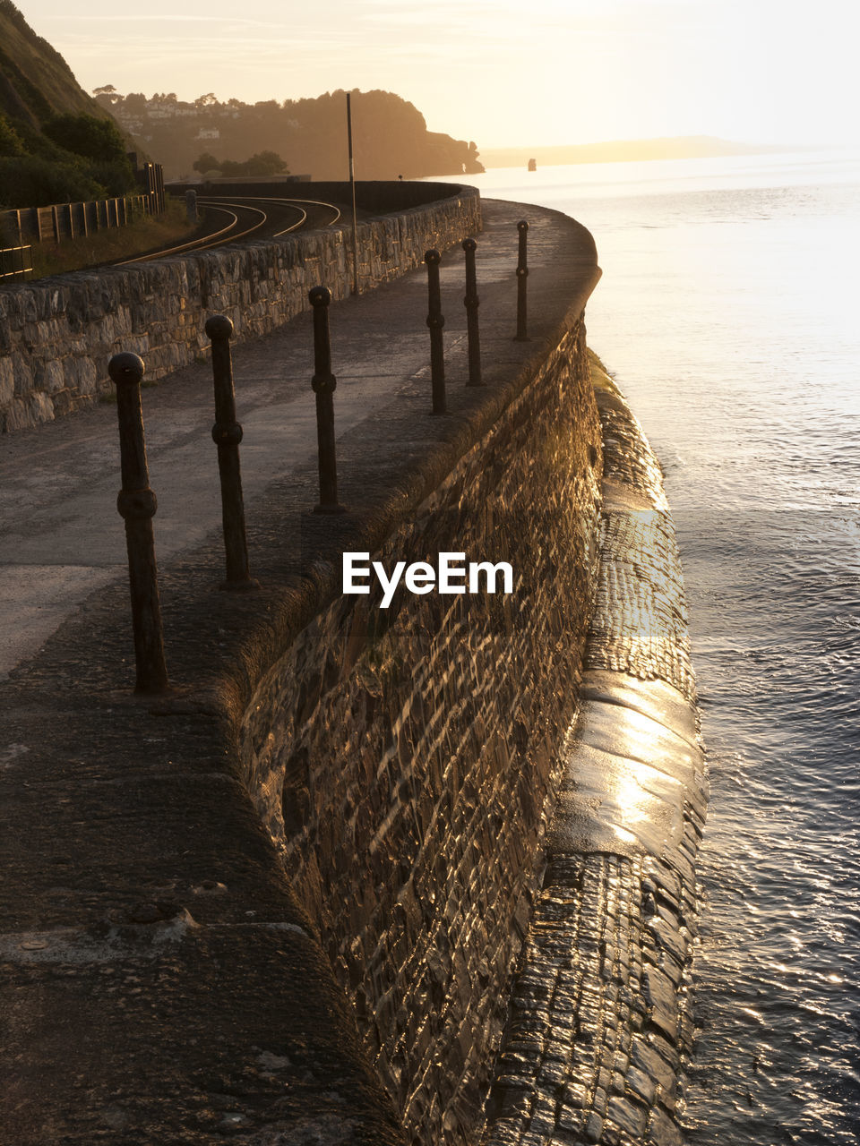 Pier at beach during sunset