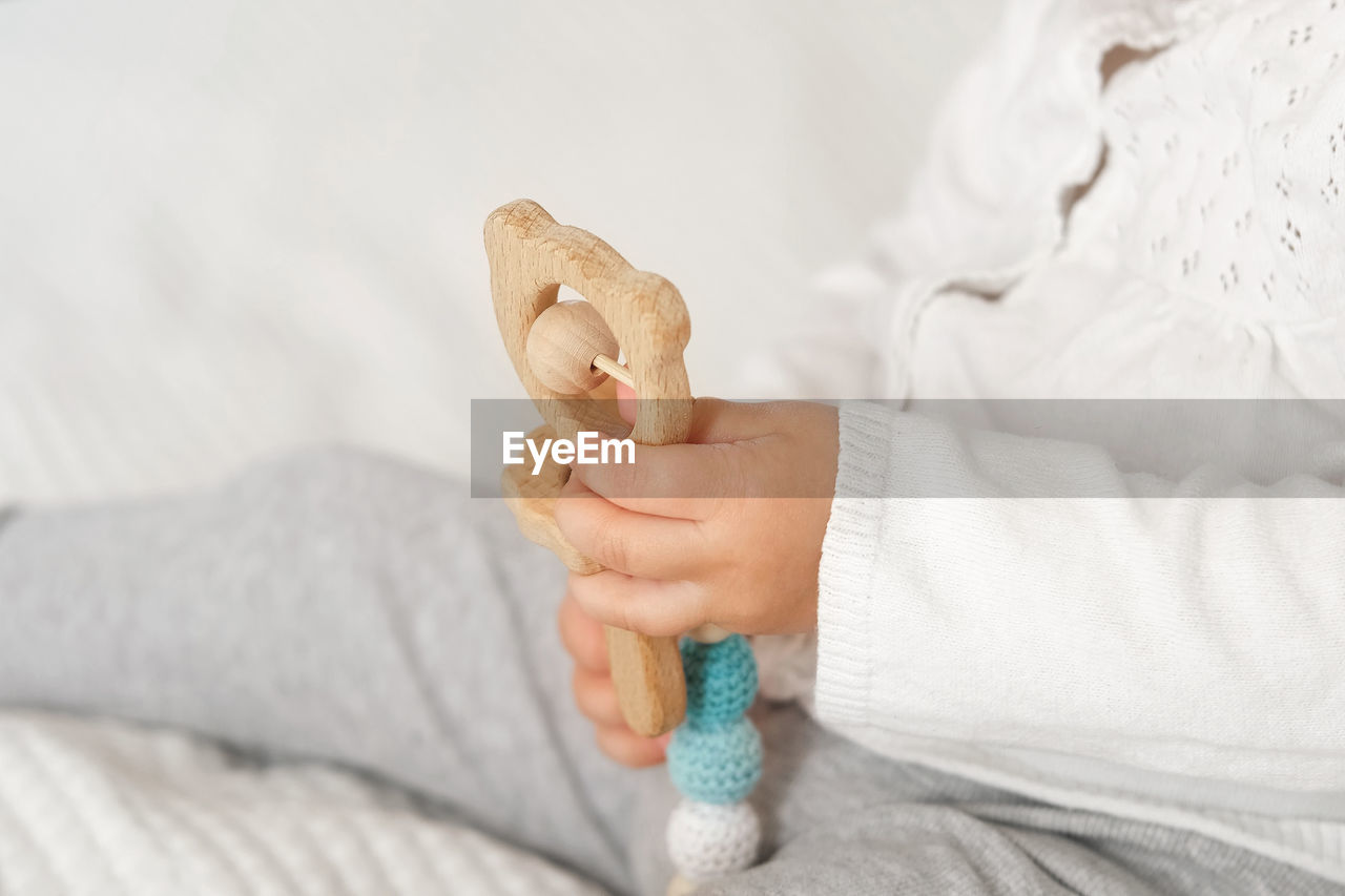 cropped hand of dentist holding dentures