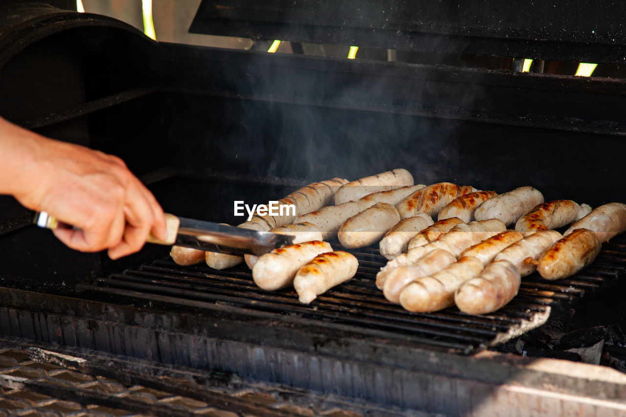 Grilled meat sausages on charcoal grill, outdoor picnic