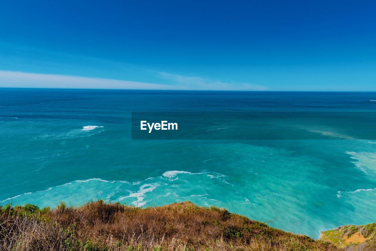 Scenic view of sea against clear blue sky