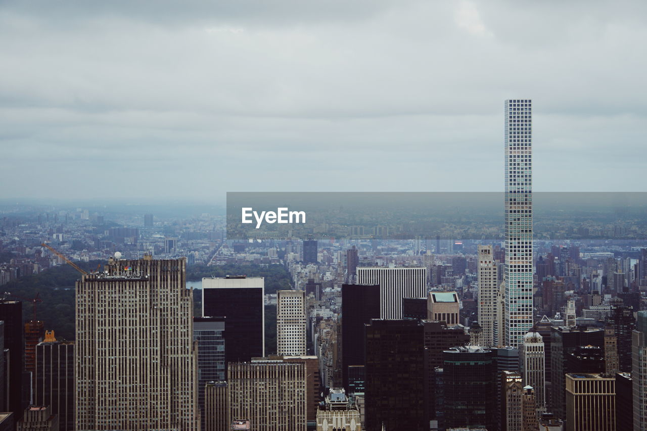 Cityscape against cloudy sky