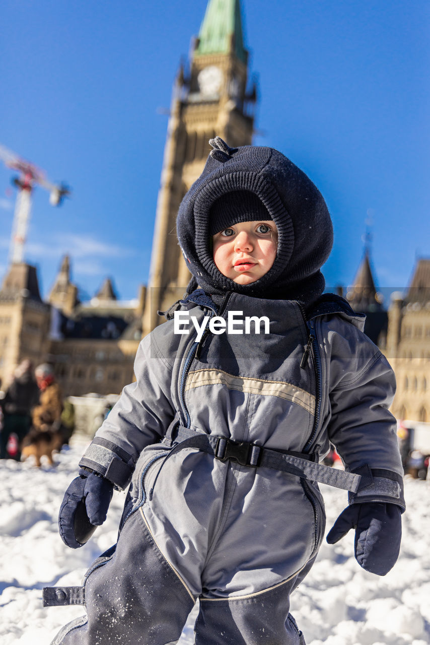 low angle view of boy standing on snow