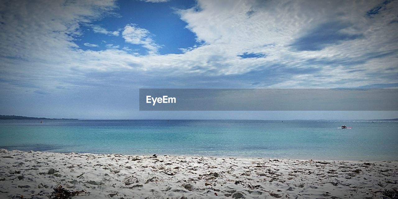 SCENIC VIEW OF BEACH AGAINST BLUE SKY