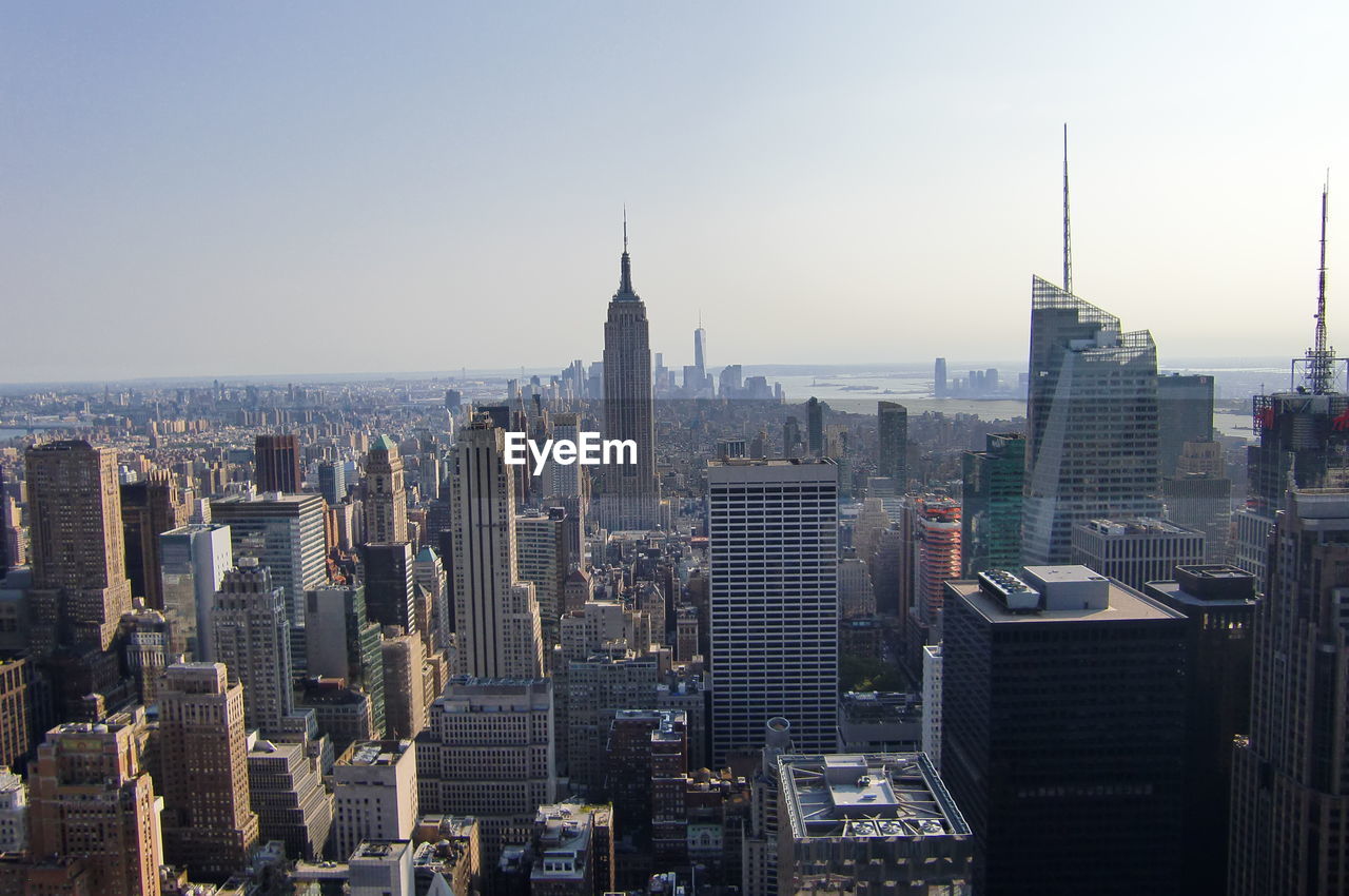 Empire state building with cityscape against sky