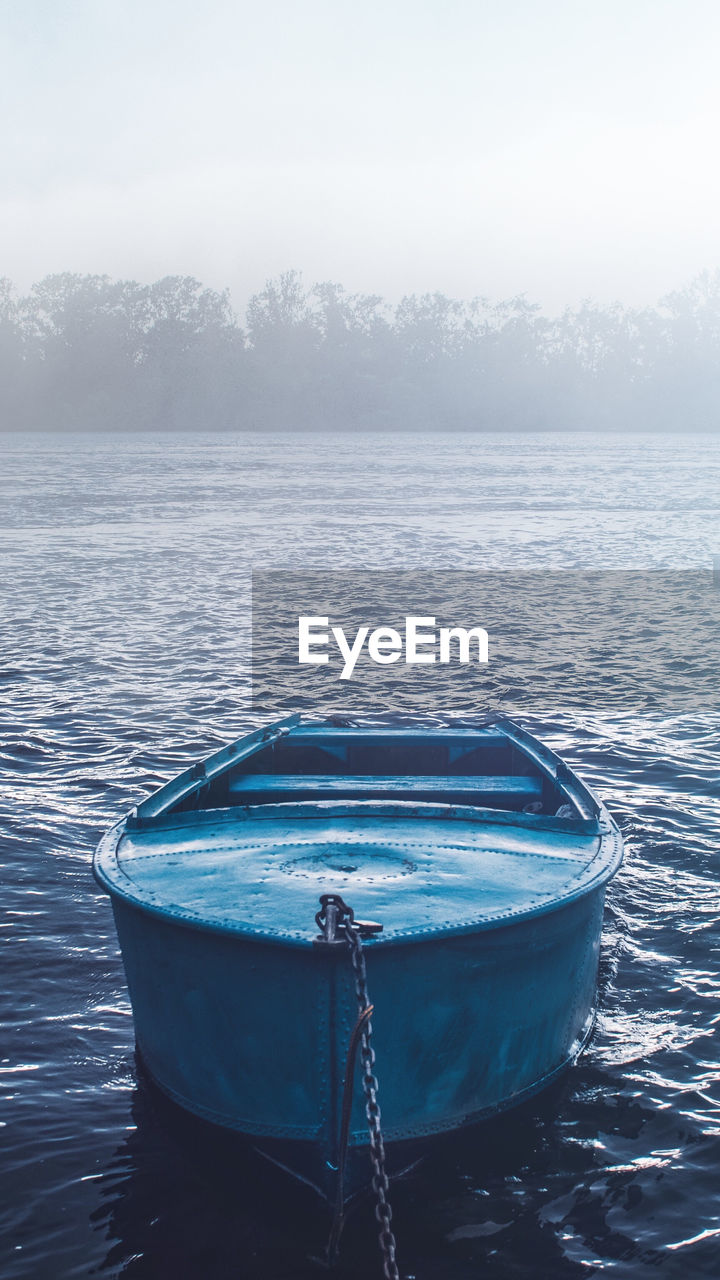 BOAT IN SEA AGAINST SKY