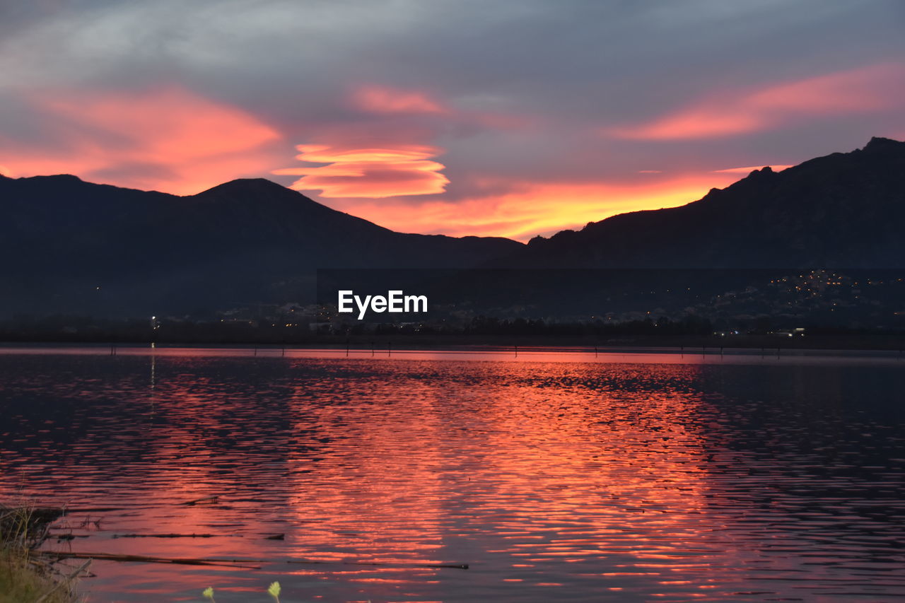 SCENIC VIEW OF LAKE AGAINST ROMANTIC SKY DURING SUNSET