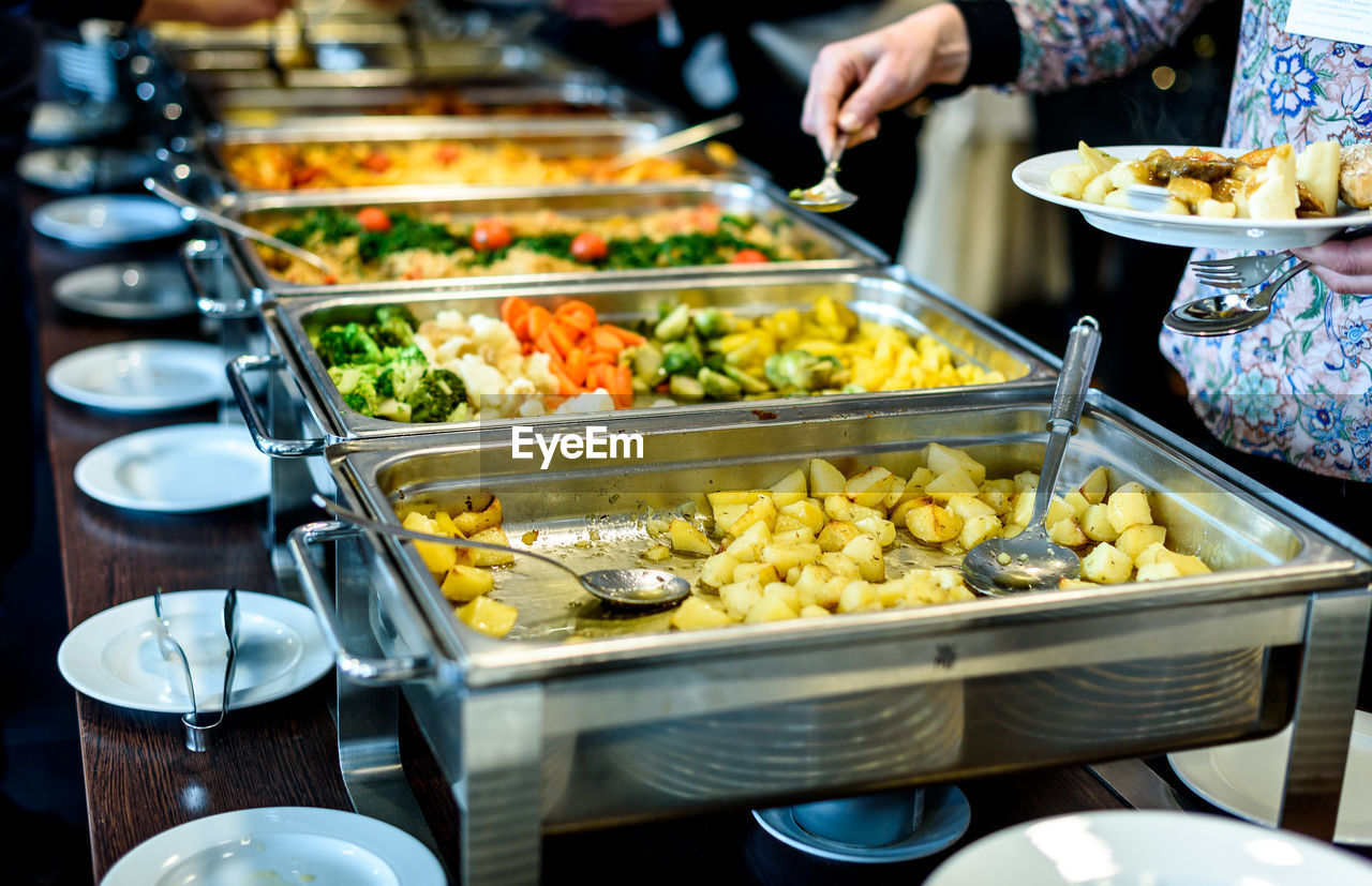 Cropped image of hand taking food