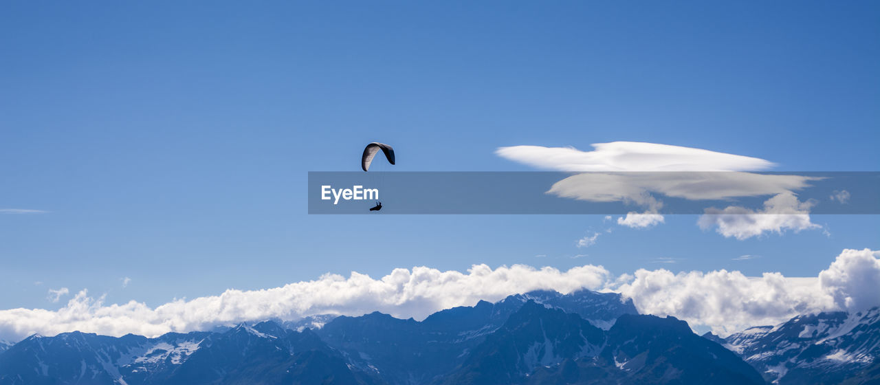 Single paraglider in the swiss alps at verbier.