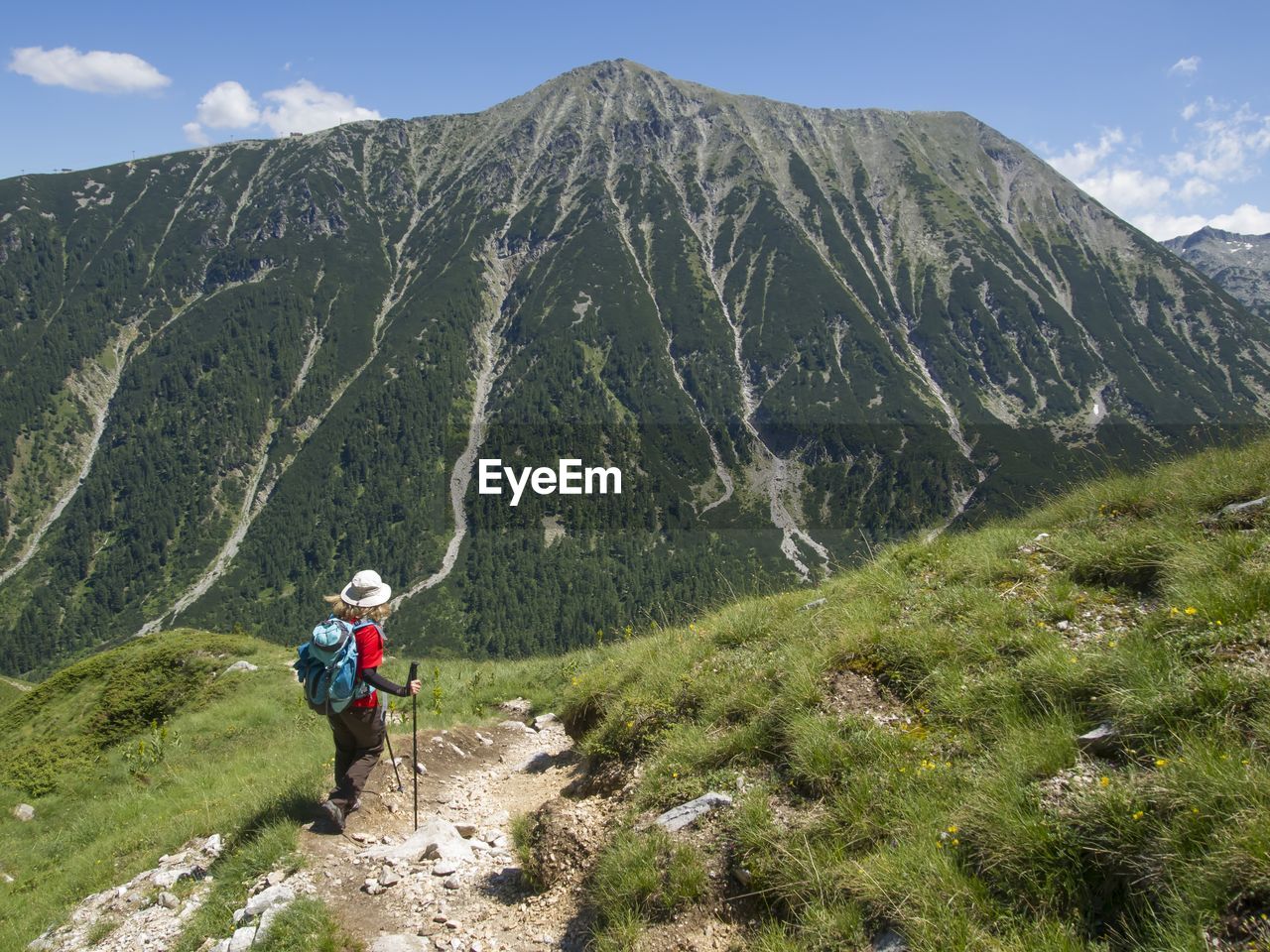 Woman standing on mountain against sky