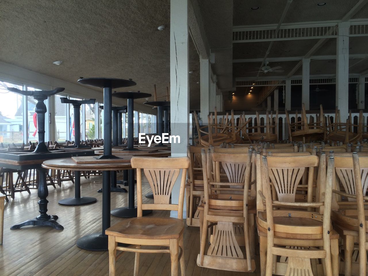 EMPTY CHAIRS AND TABLES IN ROOM