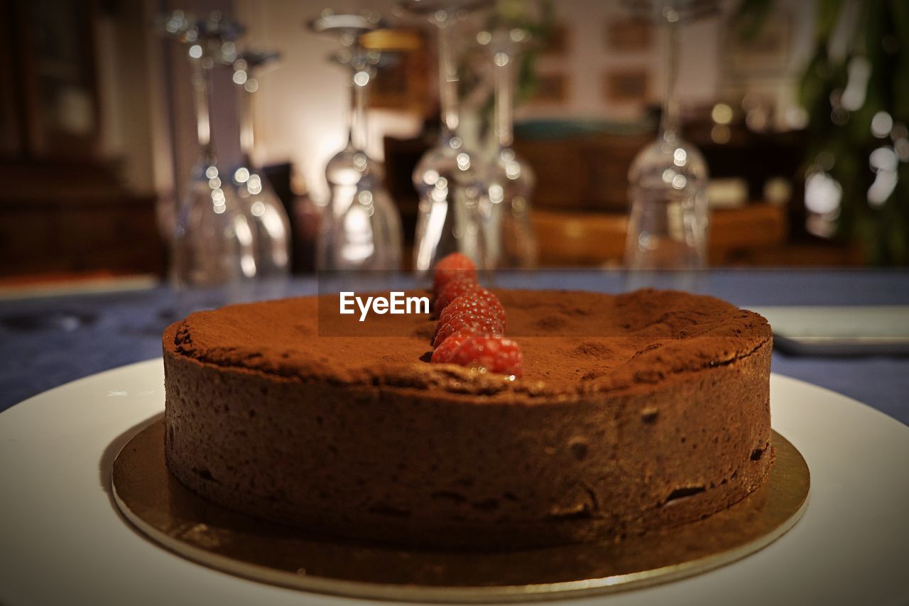 Close-up of fresh chocolate birthday cake served on table