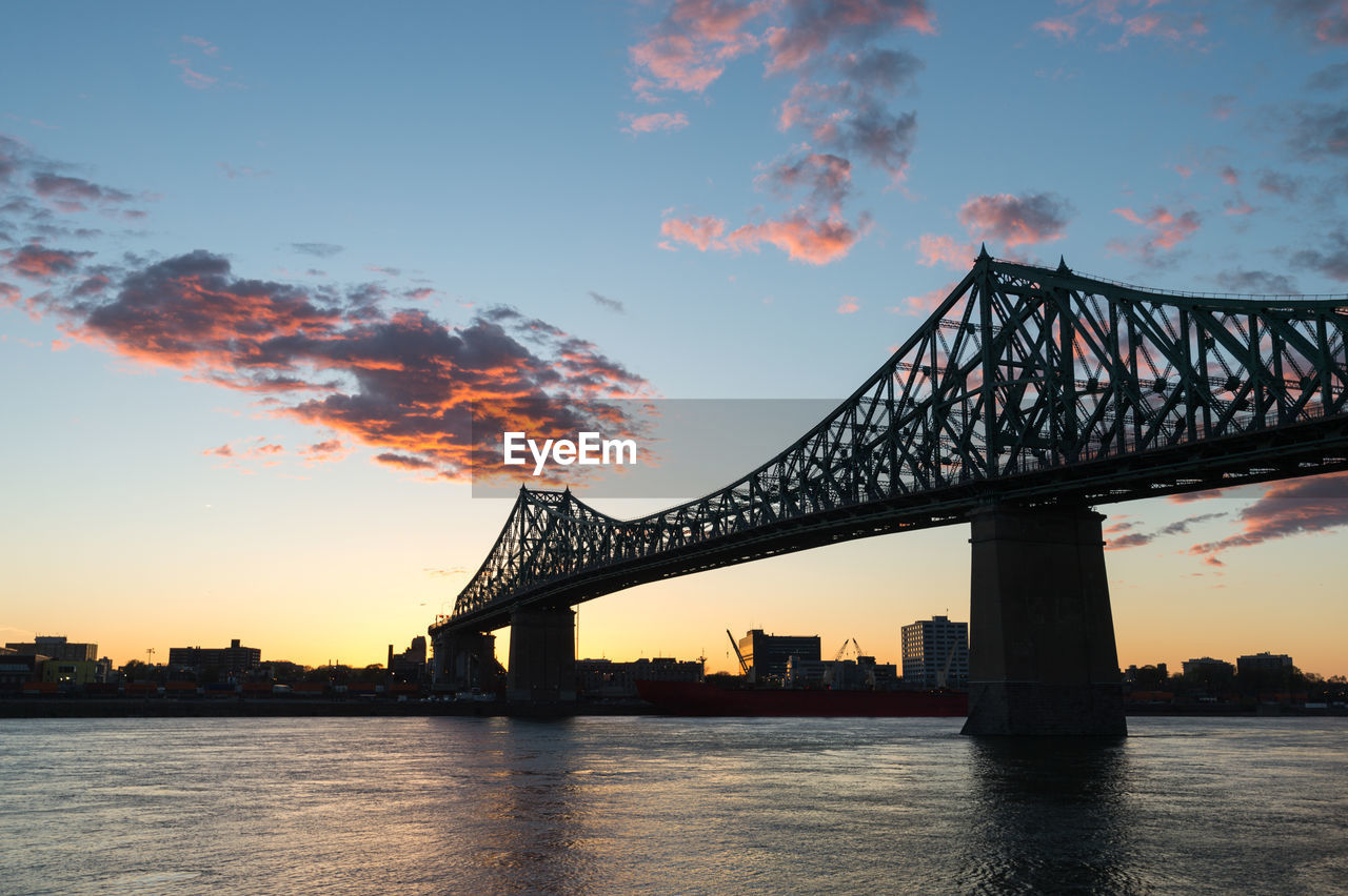 View of bridge over river during sunset