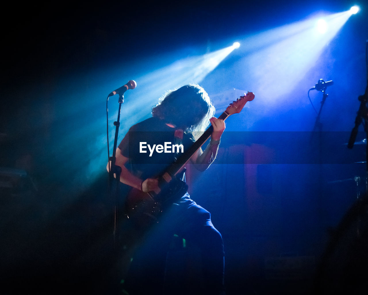 Man playing guitar at music concert