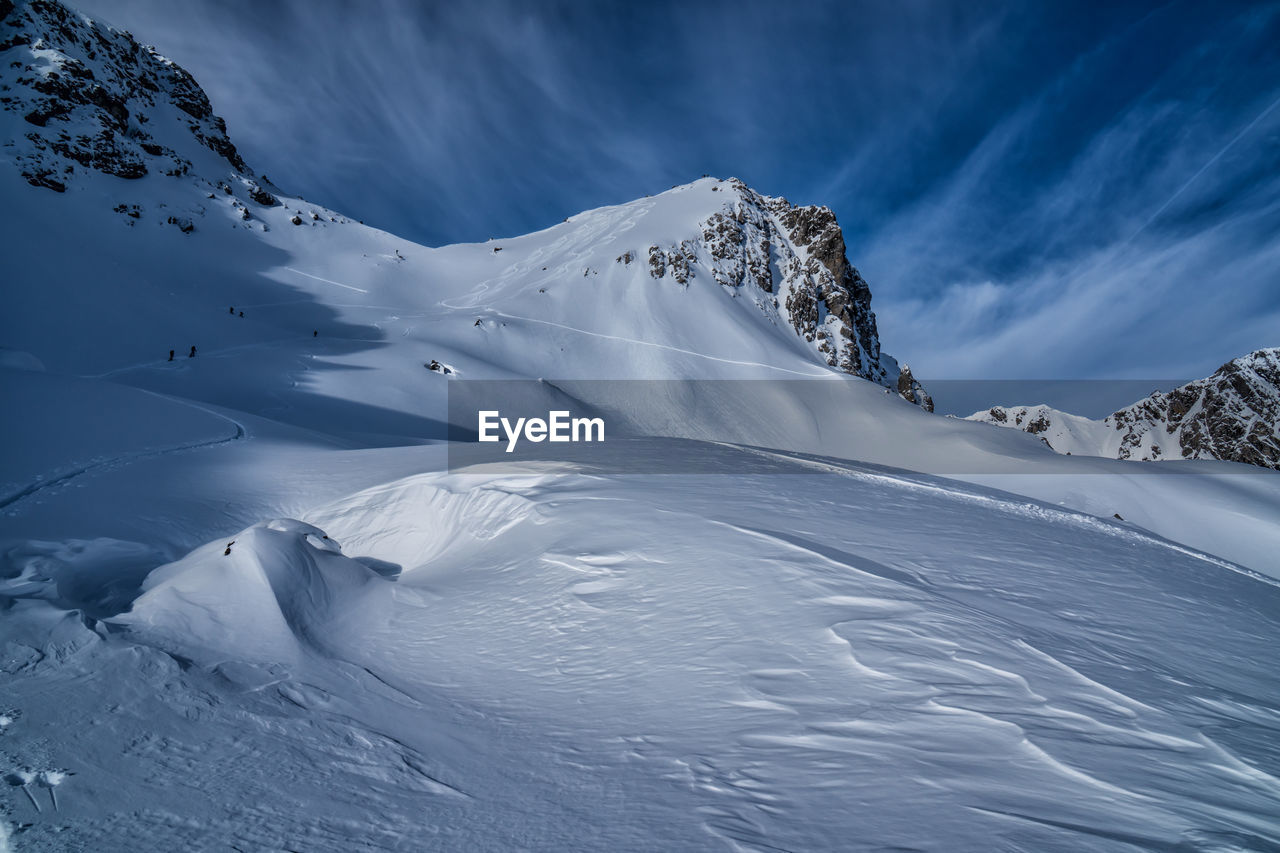 Low angle view of snowcapped mountains against sky