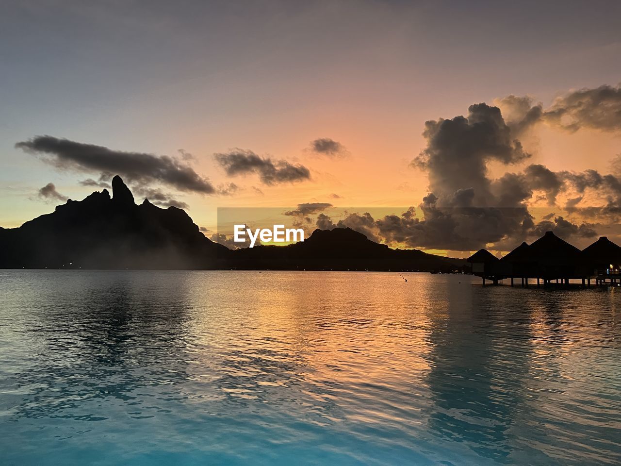 water, sky, mountain, beauty in nature, scenics - nature, sea, cloud, horizon, nature, sunset, reflection, environment, dusk, land, tranquility, landscape, ocean, travel destinations, tranquil scene, travel, evening, bay, coast, no people, mountain range, idyllic, outdoors, tropical climate, seascape, beach, island, vacation, sun, trip, holiday, sunlight, body of water, shore, tourism, lagoon, dramatic sky, architecture, wave, twilight, summer, silhouette