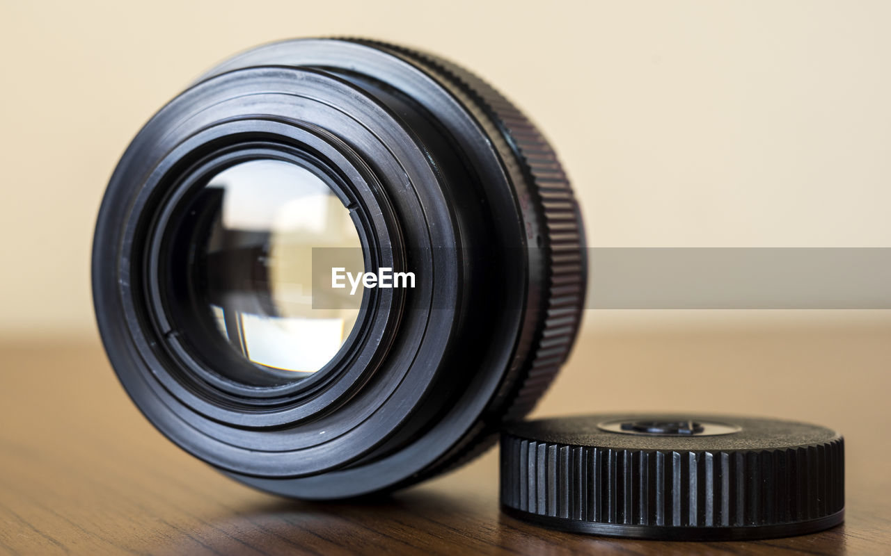 Close-up of camera lens on table