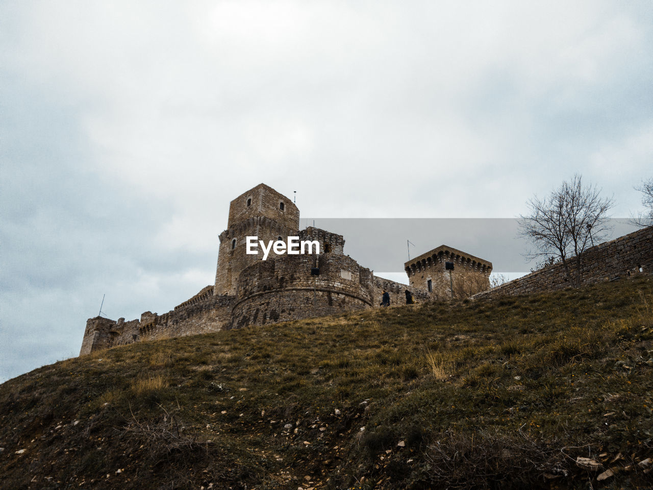 Low angle view of fort on mountain against sky