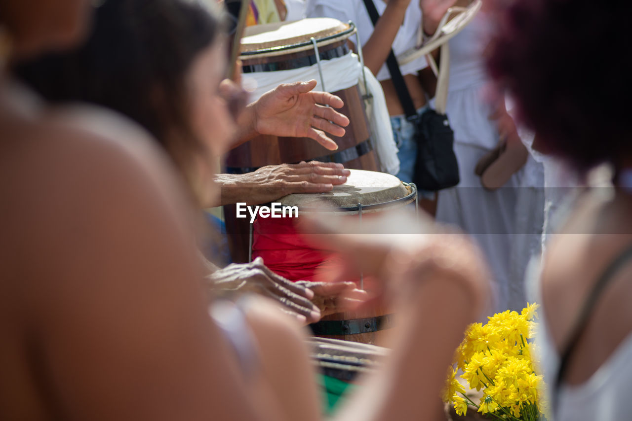 Musicians play percussion during a party for iemanja 