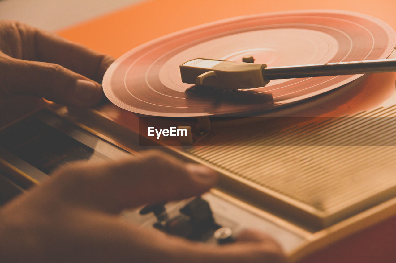 Close-up of hand playing turntable