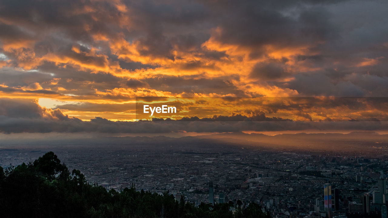 Scenic view of cityscape against sky during sunset
