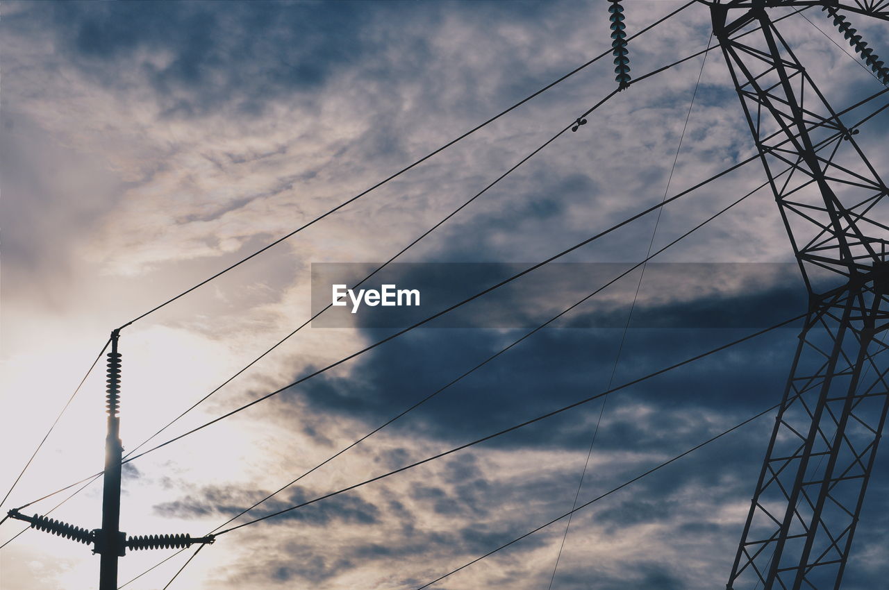 Low angle view of electricity pylon against sky