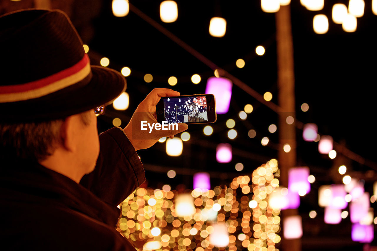 PORTRAIT OF MAN PHOTOGRAPHING ILLUMINATED SMART PHONE