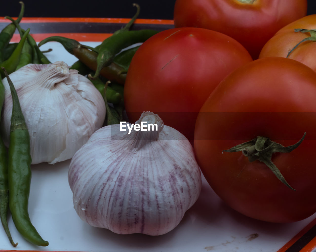 Tomato, garlic, and green chilli close up