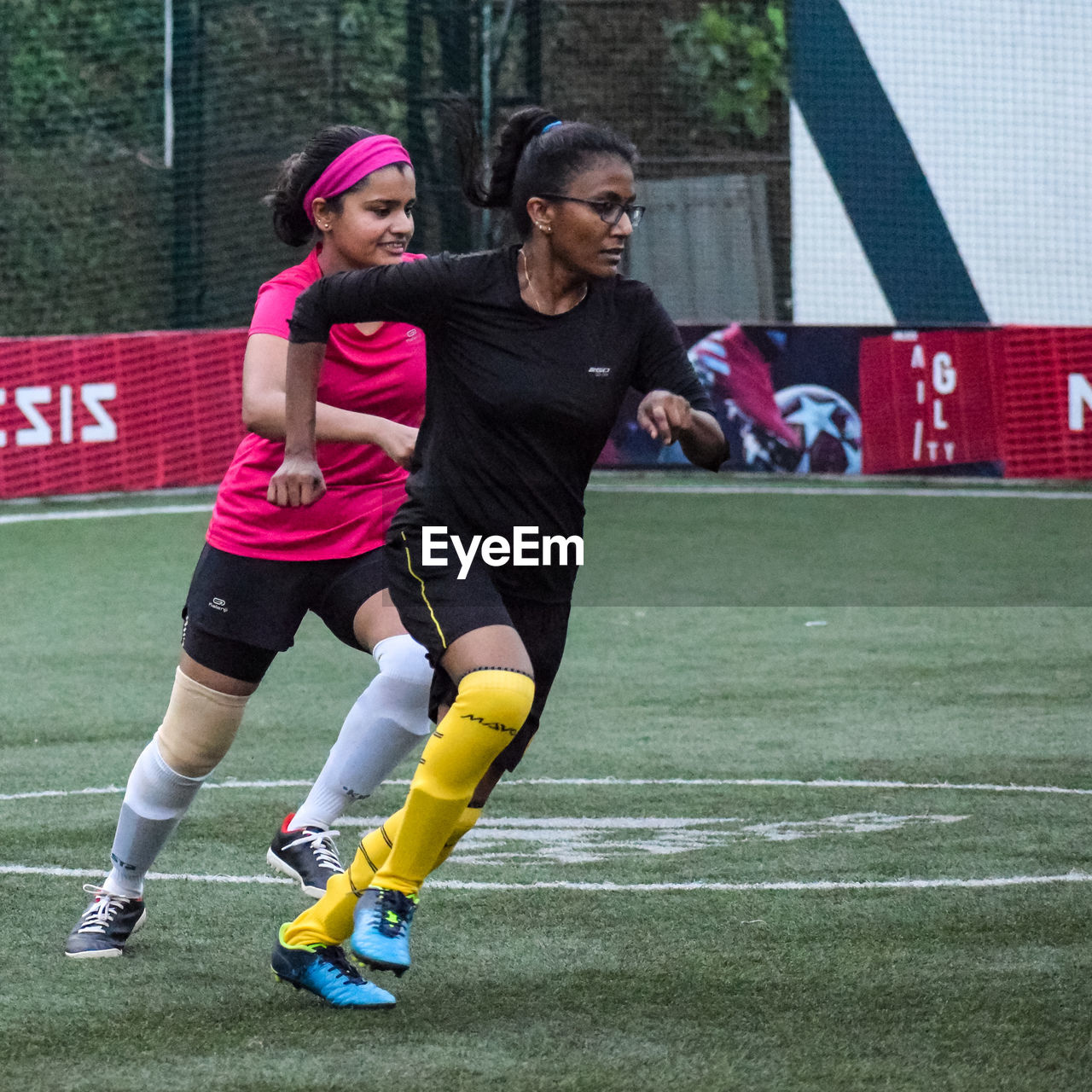 sports, player, two people, ball game, full length, adult, young adult, clothing, football player, women, sports clothing, team sport, athlete, lifestyles, tournament, soccer, togetherness, motion, exercising, competition, leisure activity, activity, competition event, female, child, sports equipment, outdoors, day, vitality, architecture