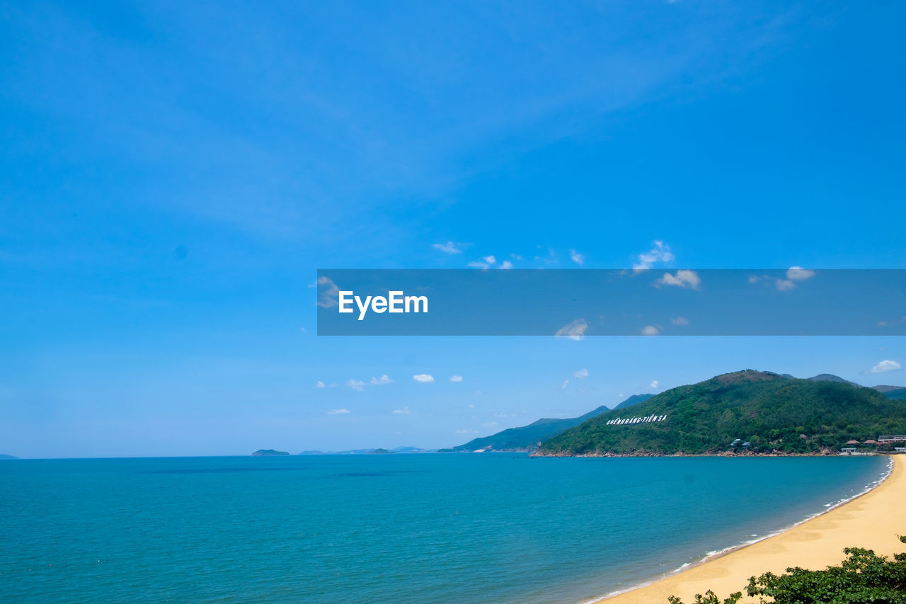 SCENIC VIEW OF BAY AGAINST BLUE SKY