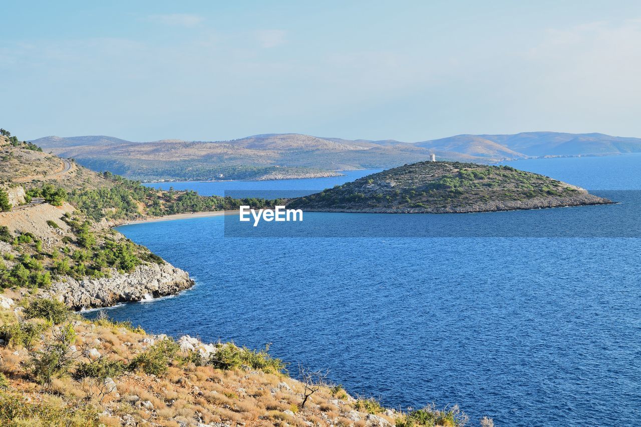 Scenic view of sea and mountains against sky