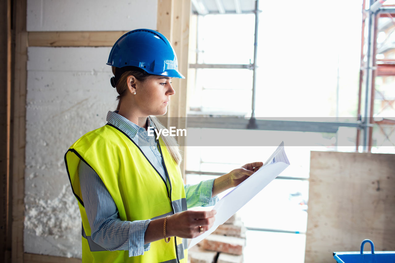 Confident female manual worker at construction site