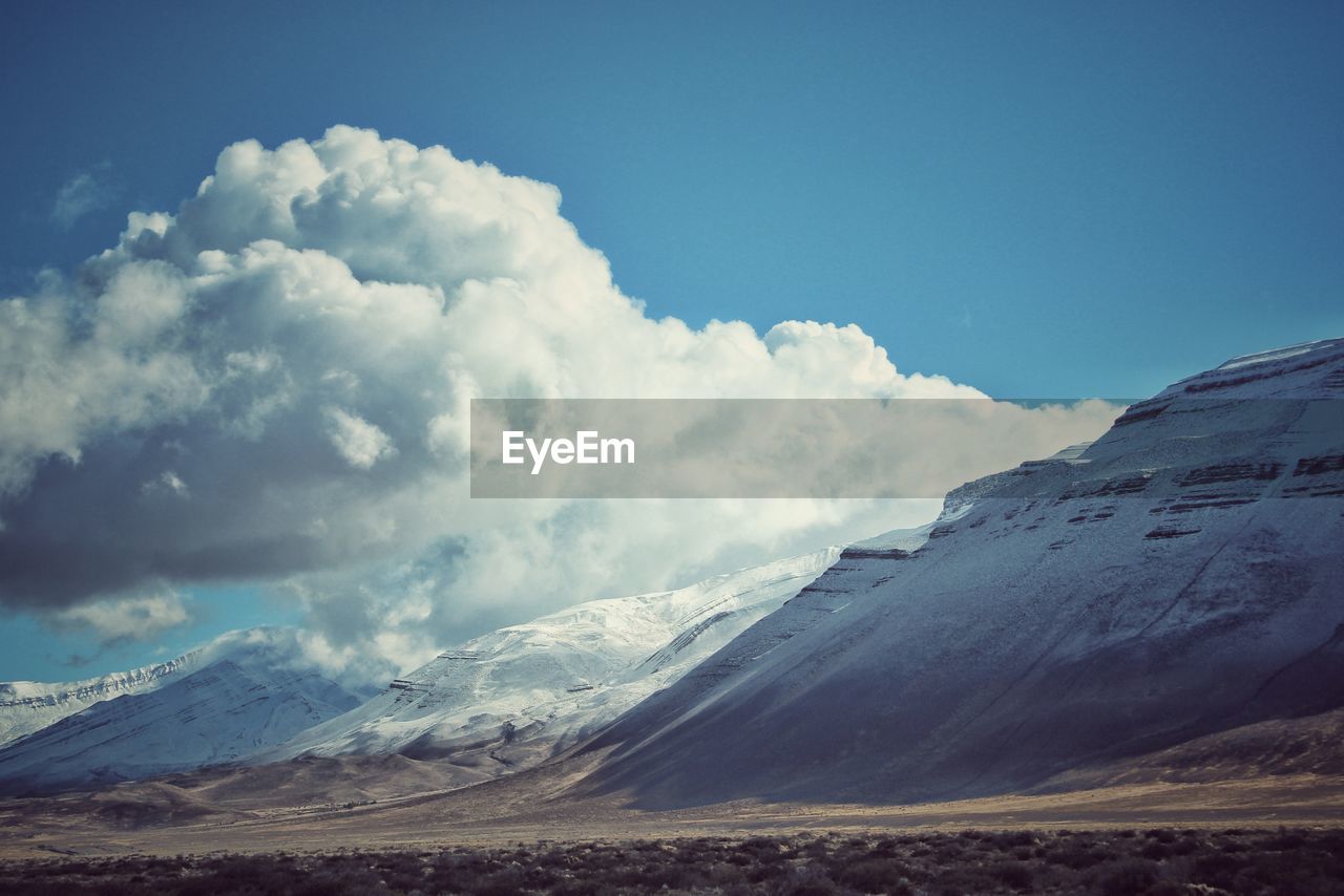 Scenic view of snowcapped mountains against sky