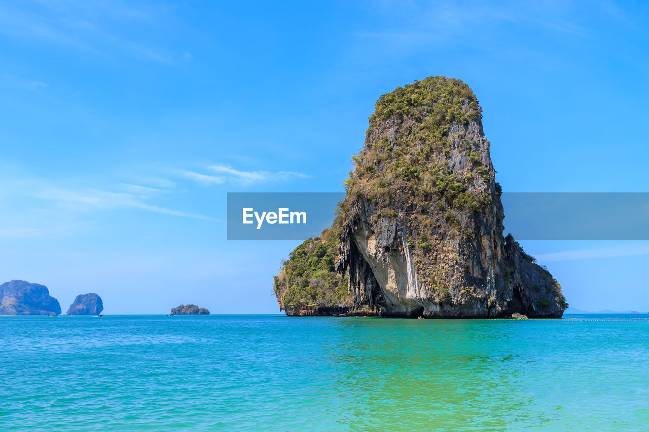 ROCK FORMATIONS IN SEA AGAINST SKY