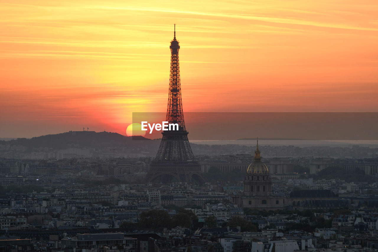 Aerial view of silhouette eiffel tower in city during sunset