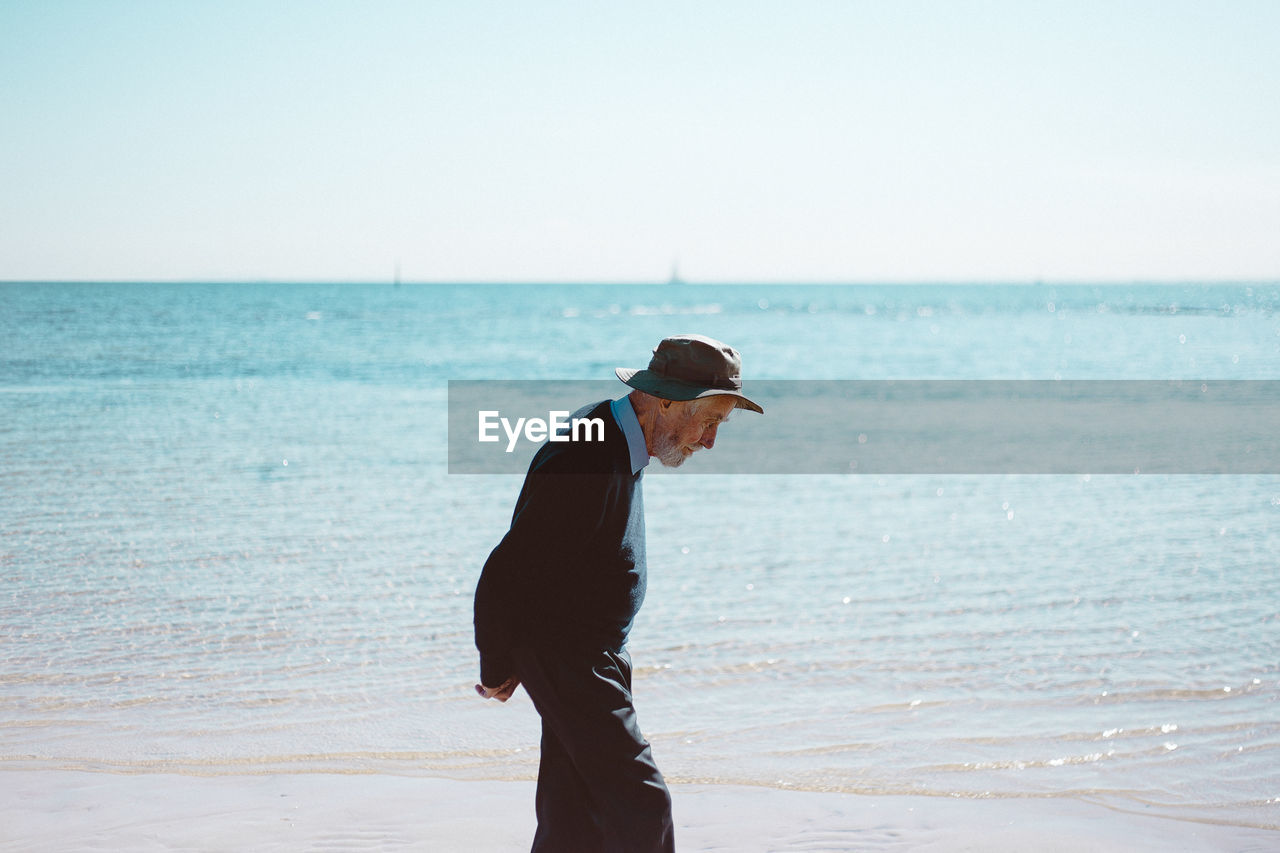 MAN STANDING ON BEACH