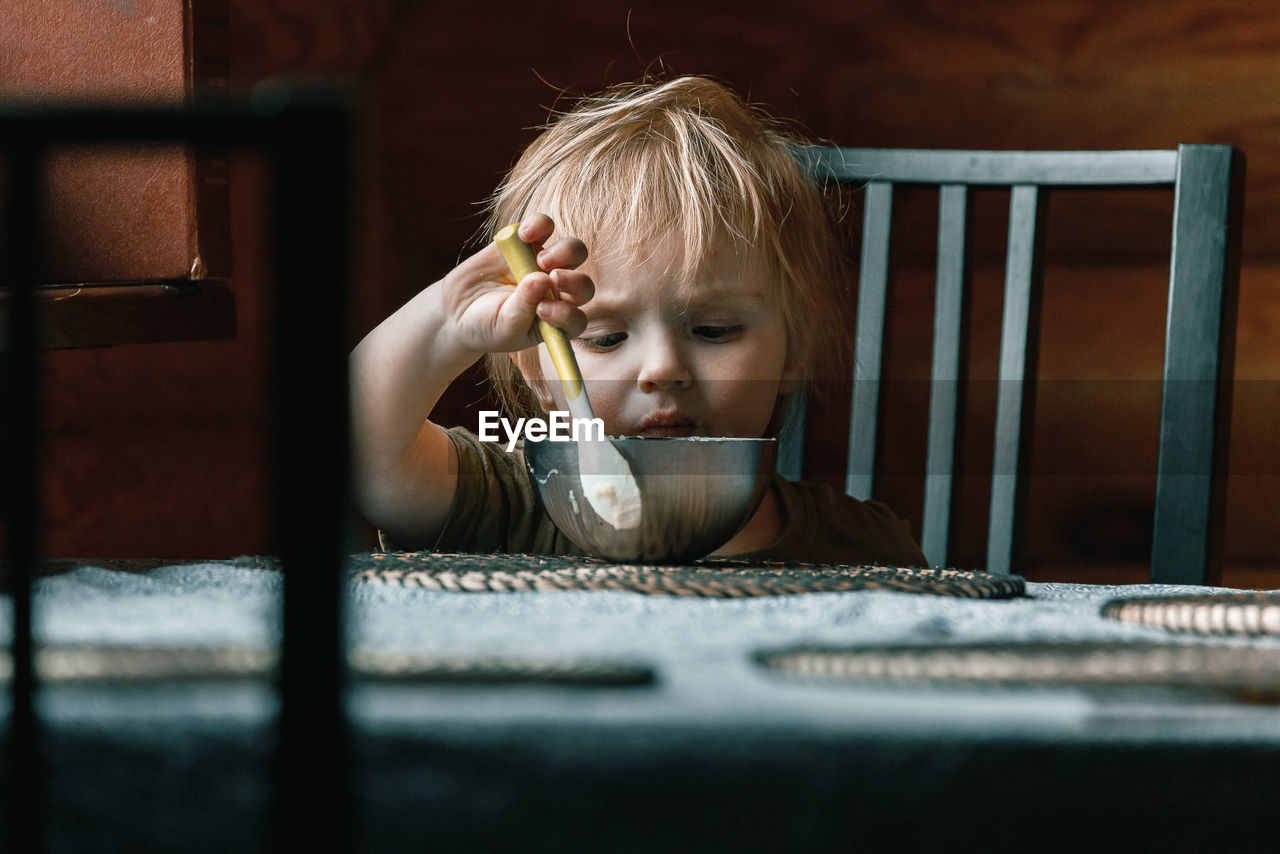 Portrait of cute boy sitting on table